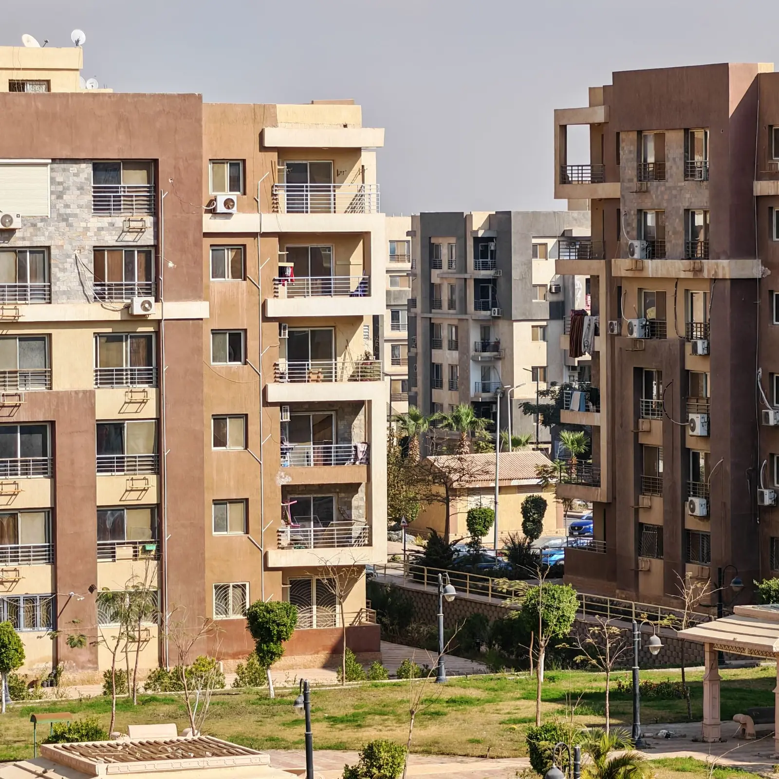 Mid-rise apartment buildings with balconies around a garden