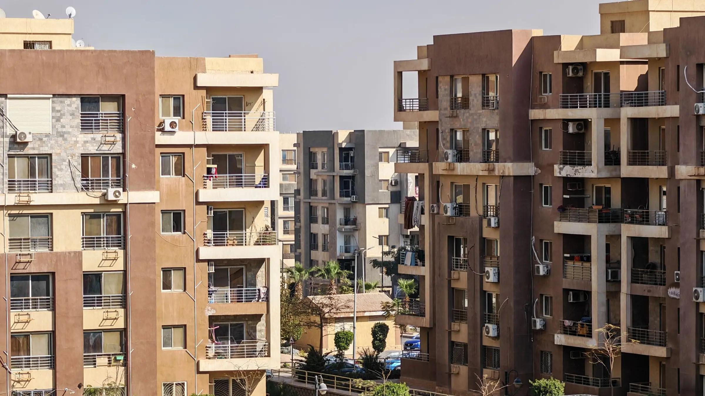 Mid-rise apartment buildings with balconies around a garden