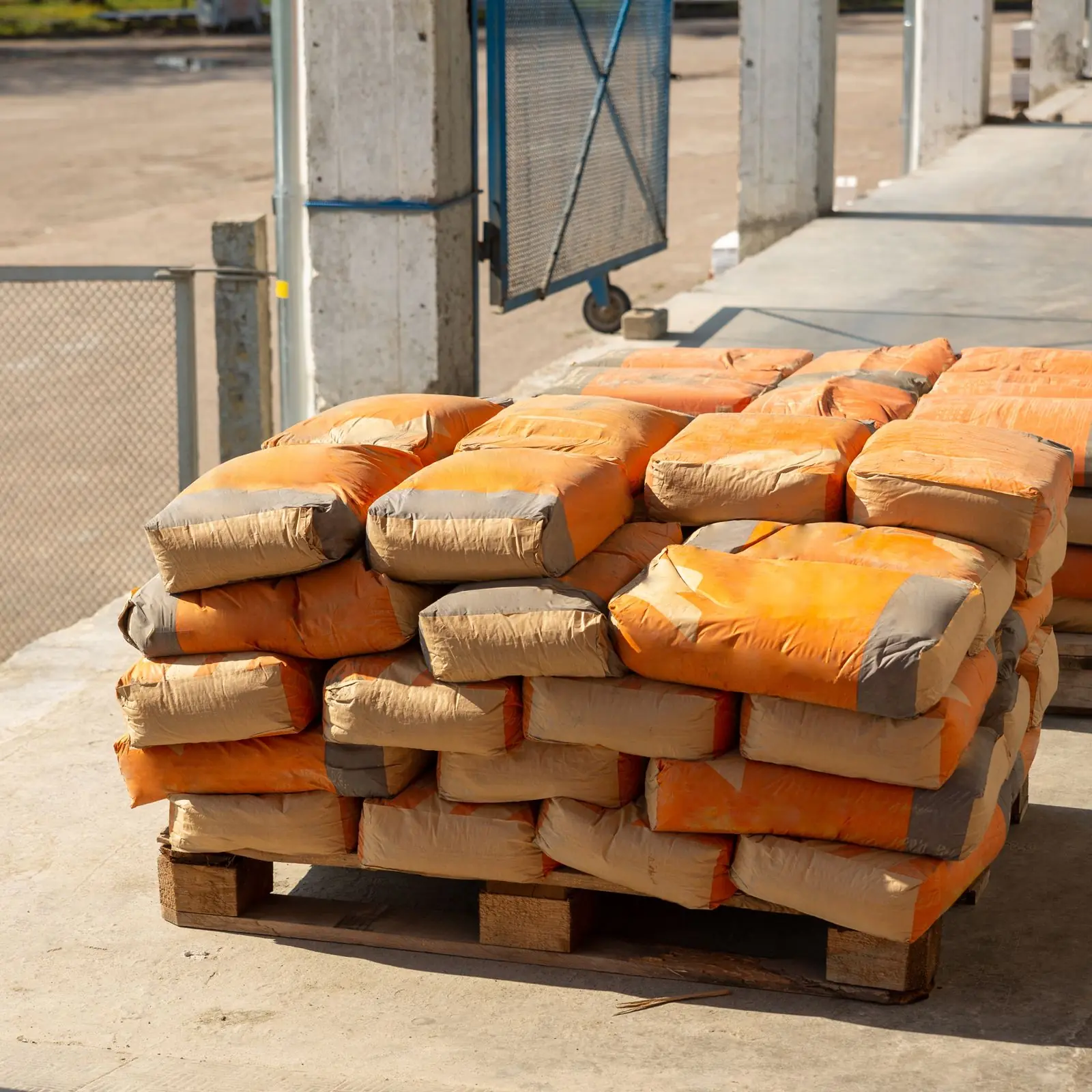 Stacked bags of cement on a wooden pallet