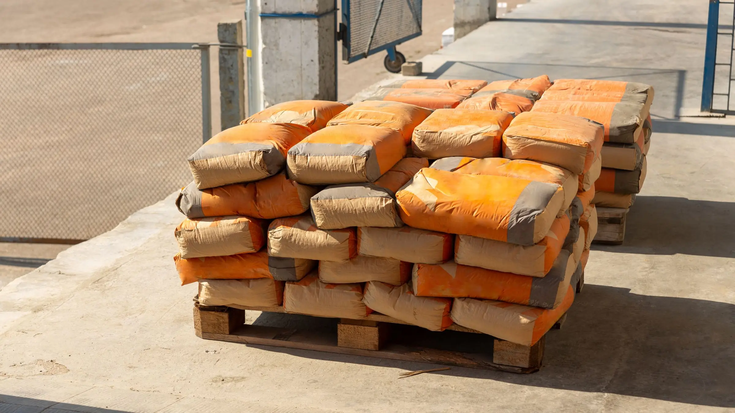 Stacked bags of cement on a wooden pallet