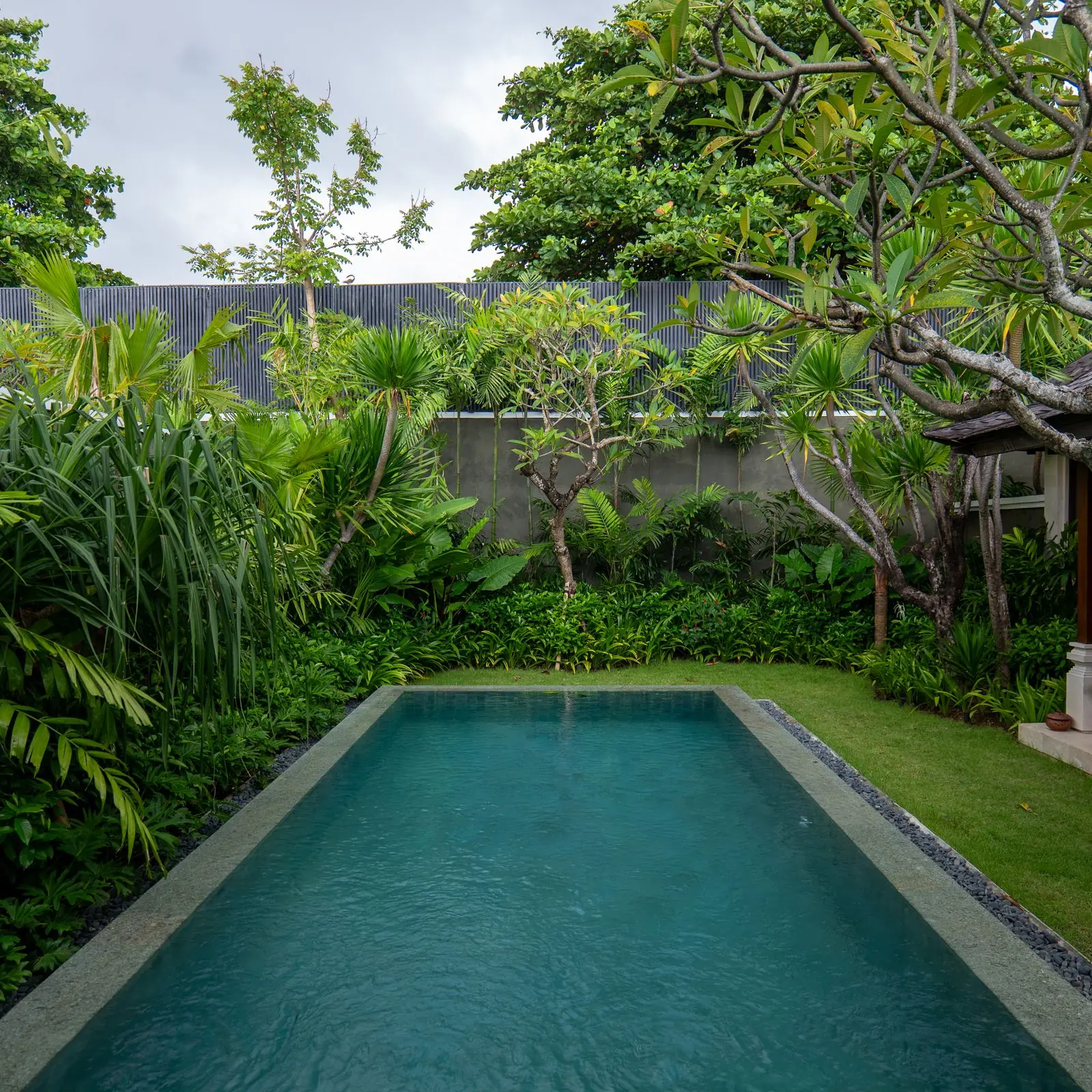 Long swimming pool in a tropical villa garden