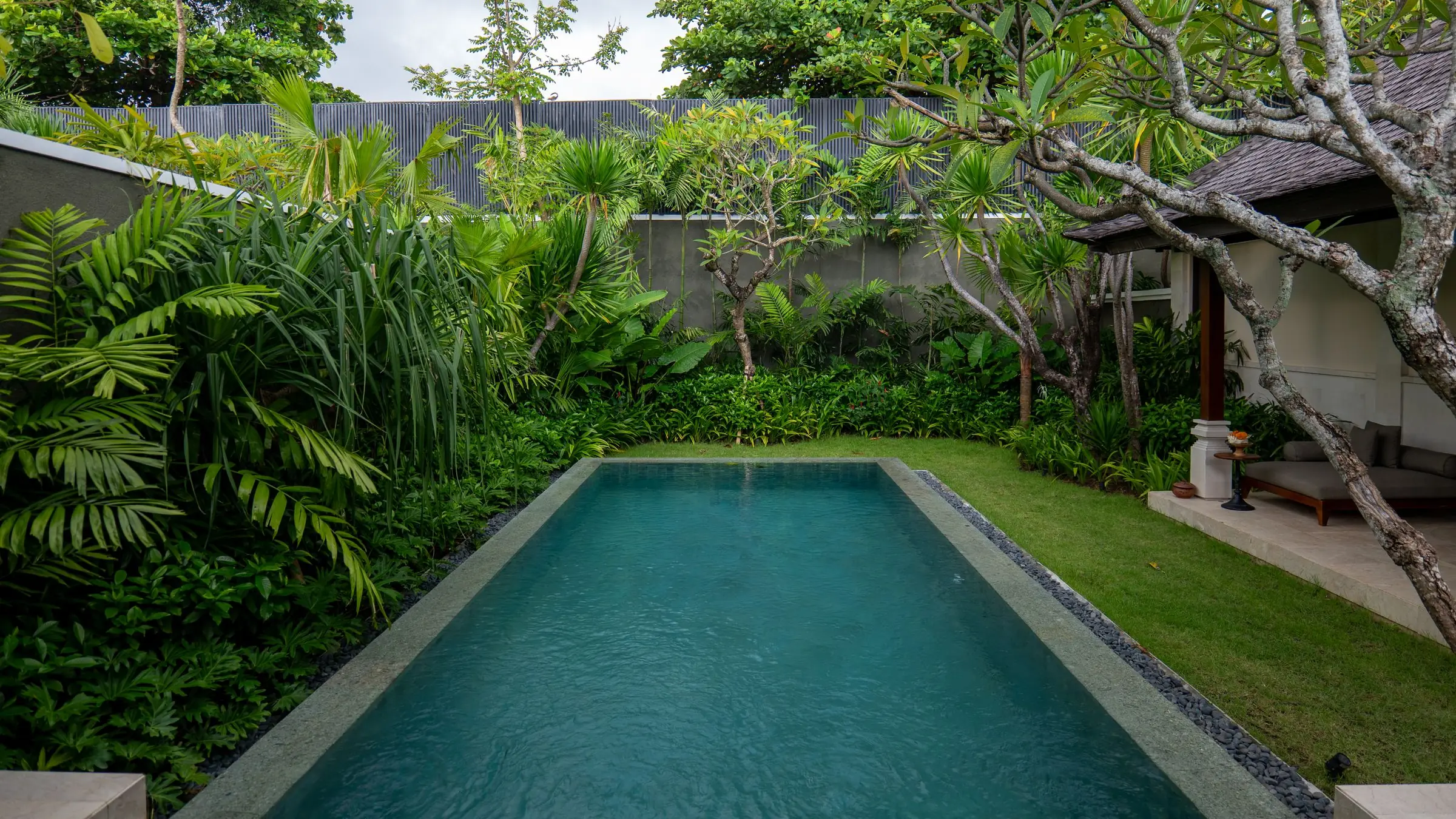 Long swimming pool in a tropical villa garden